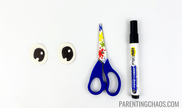 bee paper plate craft step 7 - cut  out white circles and design the eyes with black marker