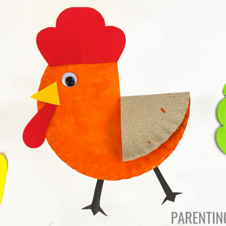 Bright and playful Little Red Hen paper plate craft featuring an orange-painted plate with a red comb, yellow beak, red wattle, googly eye, and brown wing, surrounded by colorful paper mushrooms and trees on a white background.