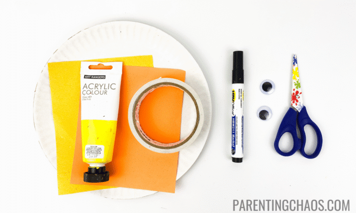 Duck paper plate craft supplies including yellow acrylic paint, orange and yellow paper, a paper plate, tape, black marker, googly eyes, and kid-safe scissors laid out on a white background.