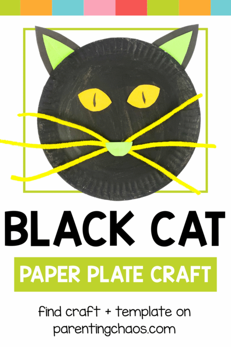 Black cat paper plate craft with green ears and yellow whiskers framed in a rainbow banner design.