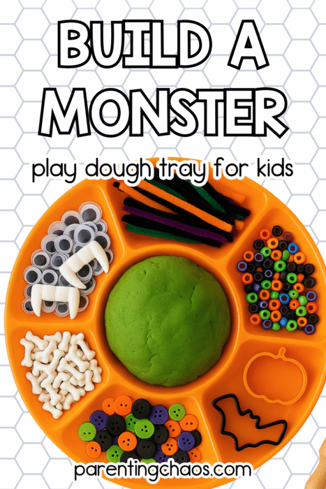 Orange tray with Halloween loose parts: vampire fangs, googly eyes, buttons, beads, bones, and green playdough.