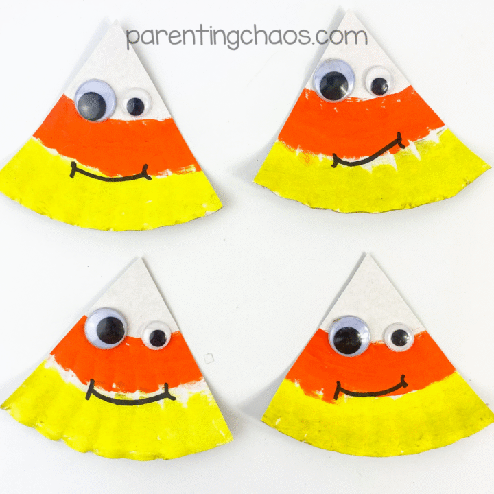 Finished candy corn paper plate crafts with big googly eyes and happy faces, ready for display.