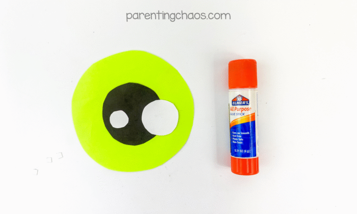 Green paper circle with black pupil and white highlights glued in place to create the eyeball center.