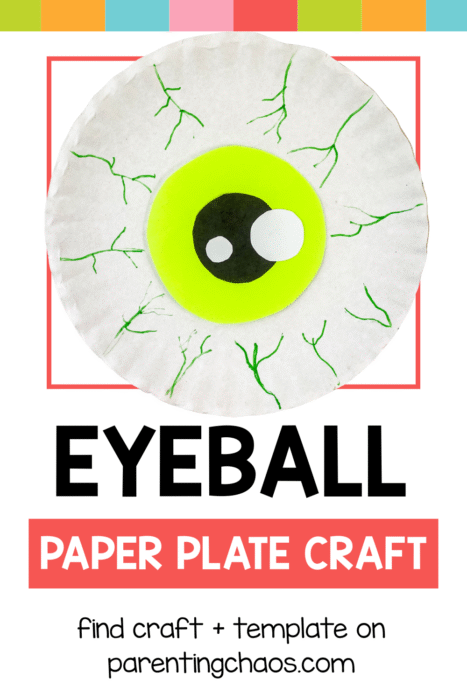 A paper plate eyeball craft with bright green iris, black pupil, and green veins, displayed with colorful banner accents.