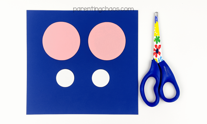 Pink and white paper circles cut out for ghost’s cheeks and eye highlights.