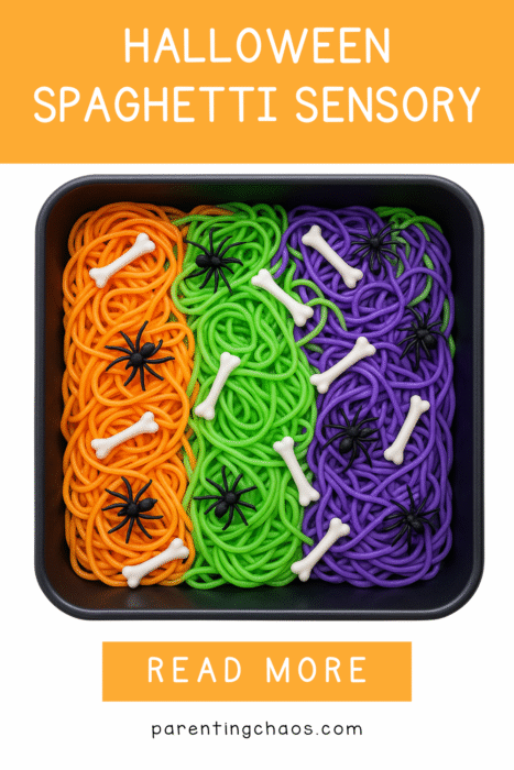 Top view of orange, green, and purple spaghetti rows with scattered bones and spiders in a sensory bin on a white background.