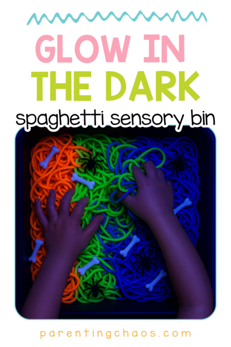 Glow spaghetti bin under UV light with orange, green, and blue noodles arranged in rows, dotted with bones and spiders.
