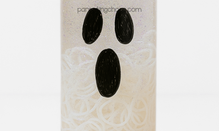 Ghost sensory bottle with white glow in the dark rubber bands added inside to create floating texture and dimension.