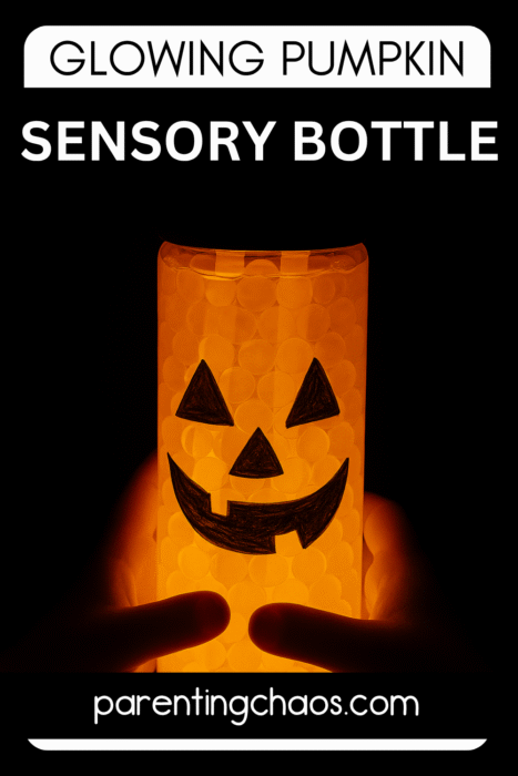 A glowing pumpkin sensory bottle sits in the dark, its jack-o’-lantern face smiling brightly. The text reads “Glowing Pumpkin Sensory Bottle.”