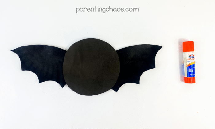 Bat wings glued to the circular body with glue stick off to the side.