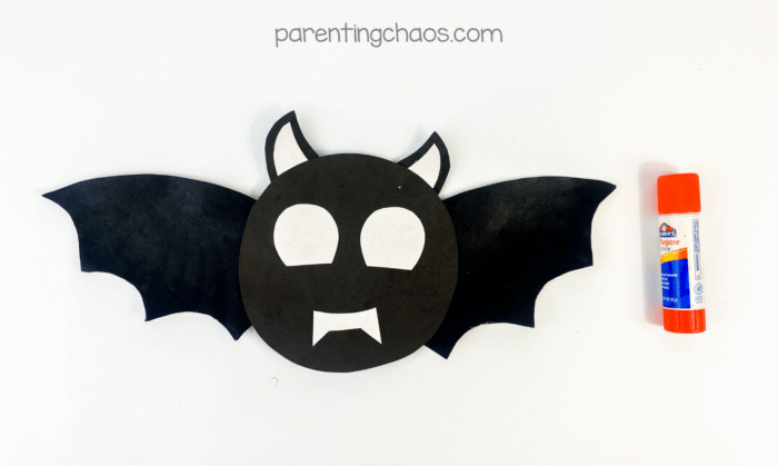 White eyes and fangs glued onto the black bat face.