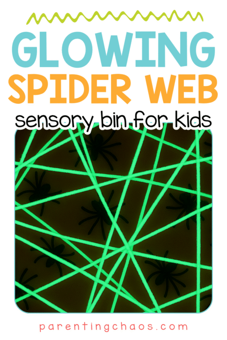 A close-up of a glowing spider web made from neon green yarn in a dark sensory bin with black toy spiders. Text reads “Glowing Spider Web Sensory Bin for Kids.”