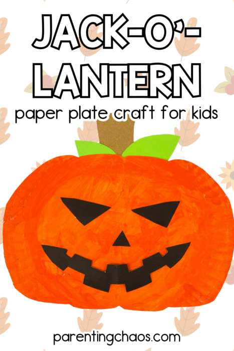 Jack-O’-Lantern paper plate craft for kids featuring a bright orange pumpkin with green paper leaves and a brown stem on a background of fall leaves. Easy Halloween art idea from Parenting Chaos.