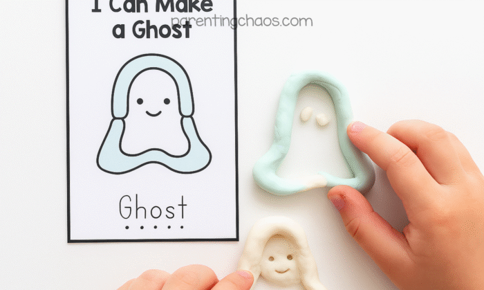 Child shaping white playdough into a ghost beside an “I Can Make a Ghost” task card. The playdough ghost matches the smiling ghost design on the card, with two small white eyes added.