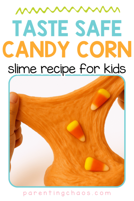 Homemade candy corn slime being stretched between two hands.