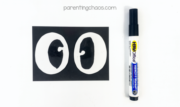 White eyes with black pupils drawn inside using a black marker.