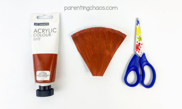 Cut paper plate section painted brown to look like broom bristles.