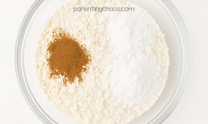 Dry ingredients for the apple pie playdough recipe in a bowl — flour, salt, and cinnamon ready to be mixed together.