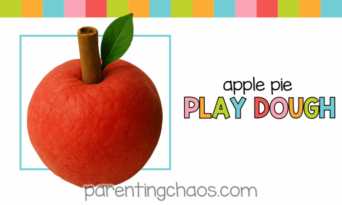 Red apple-shaped playdough ball with a cinnamon stick and leaf, labeled “Apple Pie Play Dough” on a colorful background.