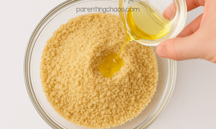 Pouring oil into a bowl of ground Cheerios to create the Cheerio taste-safe sand mixture.