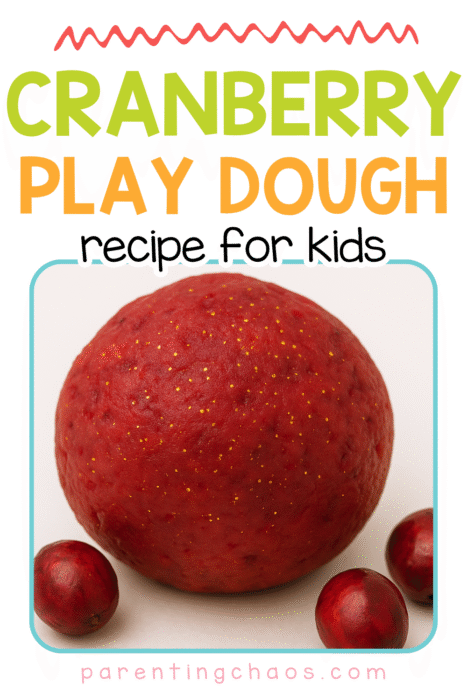 Red ball of cranberry play dough surrounded by fresh cranberries on a white background.