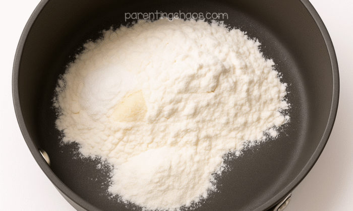 Dry ingredients for cranberry playdough in a saucepan before mixing.