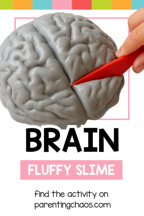 Child using a red plastic knife to cut into gray fluffy brain slime during a hands-on pretend play activity.