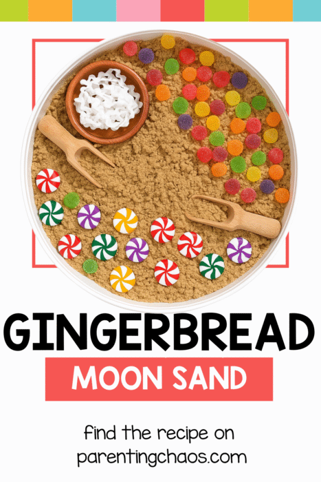 A white sensory bin filled with brown gingerbread moon sand. The setup includes wooden scoops, a bowl of white ribbon pieces, red and white peppermint candies, and colorful gumdrops. Text reads “Gingerbread Moon Sand. Find the recipe on parentingchaos.com.”