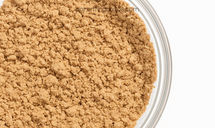 Gingerbread moon sand mixture combined, showing a soft crumbly texture in the bowl.