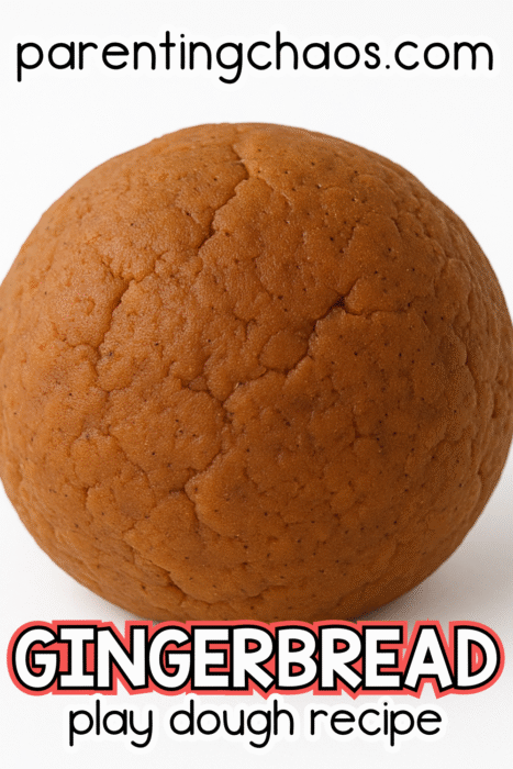 A close-up of a smooth brown ball of gingerbread play dough on a white background. Text on the image reads “Gingerbread Play Dough Recipe.”