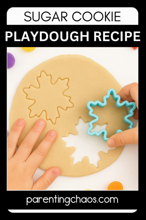 Close-up of a child using a blue snowflake cookie cutter to cut shapes from rolled sugar-cookie playdough.