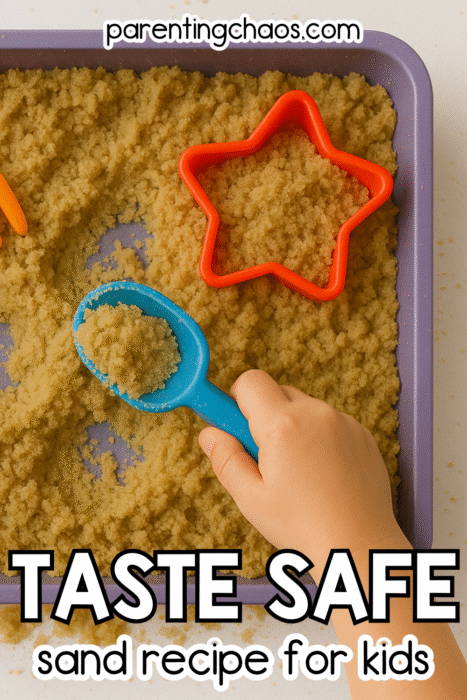 Close-up of a child’s hand holding a blue scoop of homemade taste-safe sand in a purple tray with star and fork-shaped molds.