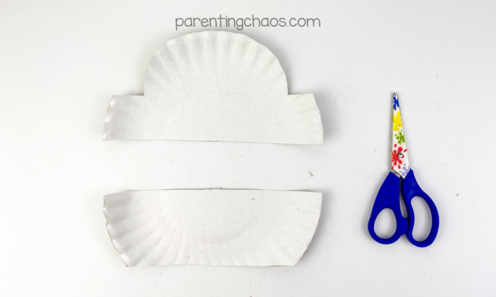 Paper plate cut into two pieces to create a treasure chest craft base for kids.