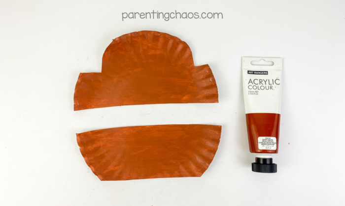 Paper plate pieces painted brown for a treasure chest paper plate craft project.